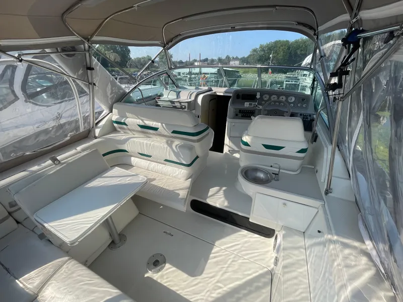 Slide: The Image of 1999 Formula 34 PC yacht interior with white seating and helm, featuring clear canopy. - 15
