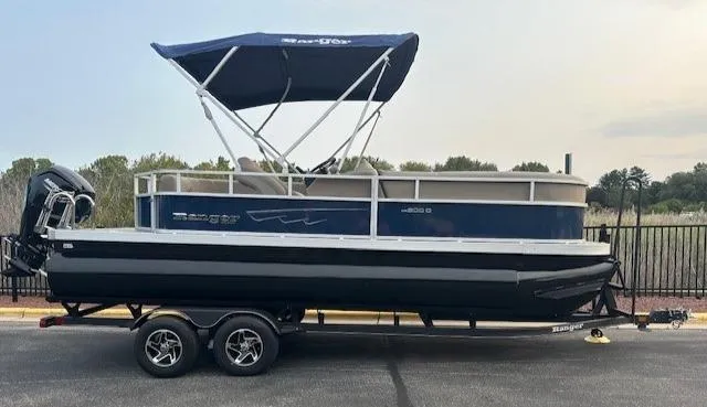 The Image of 2024 Ranger Reata 200C pontoon boat with canopy on trailer. - 0