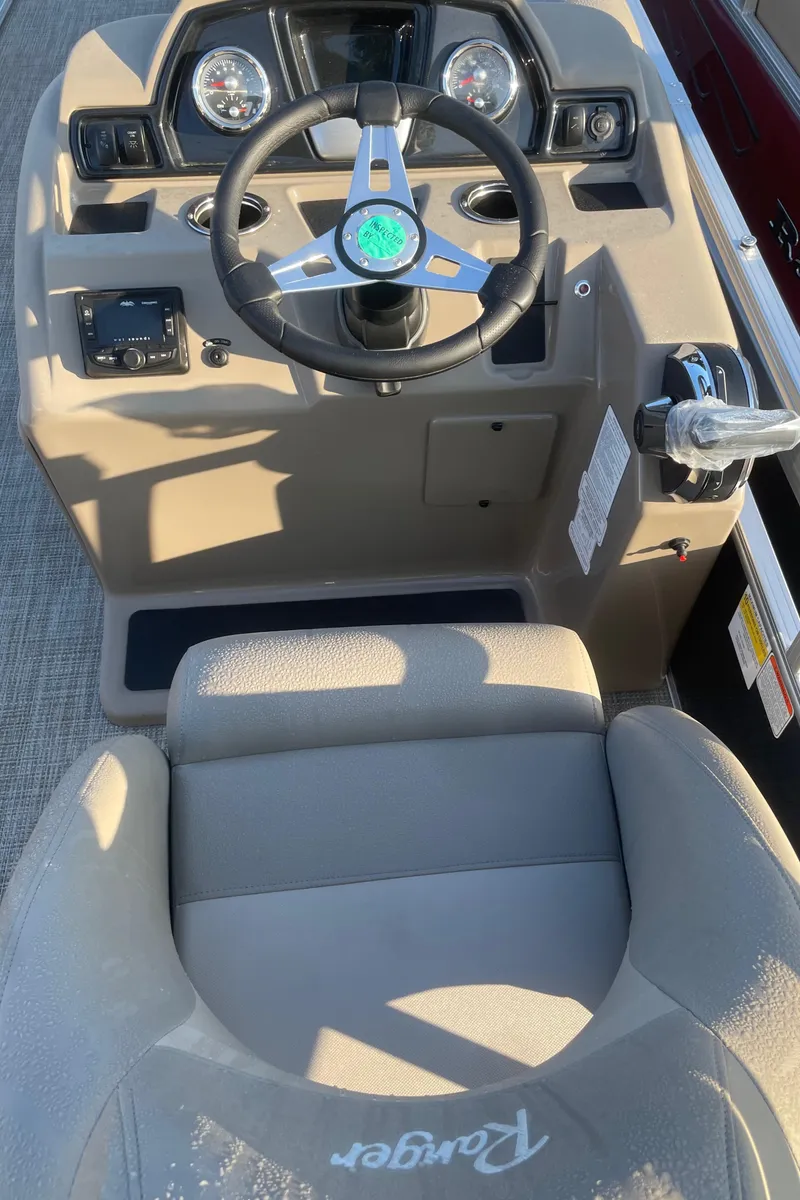 Slide: The Image of 2024 Ranger Reata 200C boat cockpit with steering wheel and controls. - 4