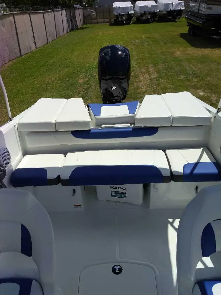 Slide: The Image of 2024 Tahoe 200 S boat interior with blue and white seating, outdoor setting. - 5