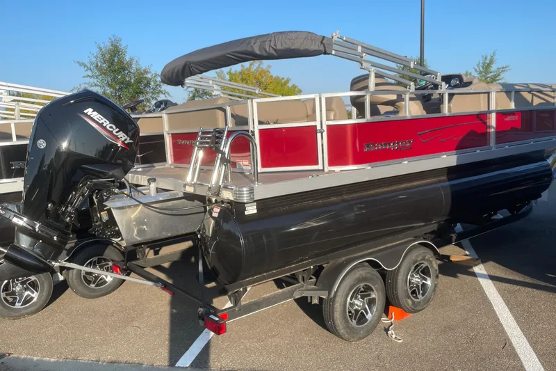 The Image of 2024 Ranger Reata 200C pontoon boat with Mercury outboard engine on trailer. - 0