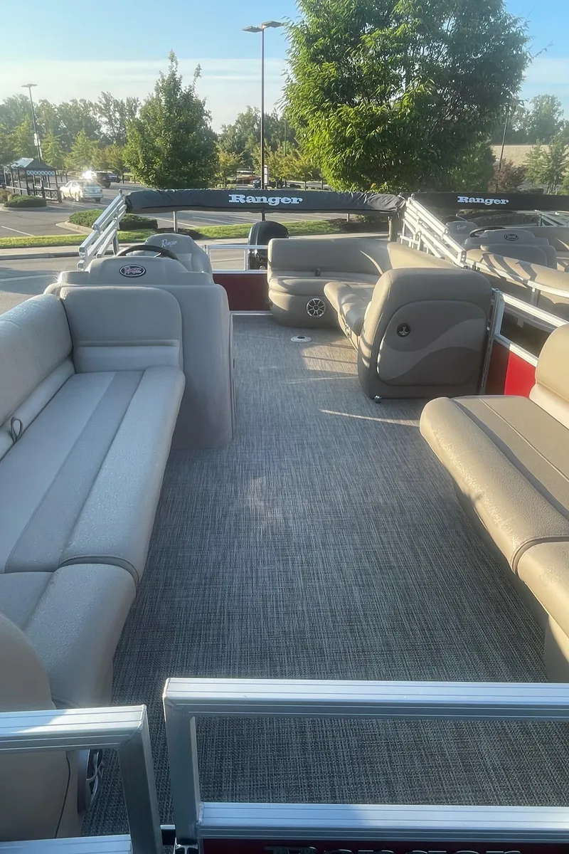 Slide: The Image of 2024 Ranger Reata 200C pontoon boat interior with spacious seating and modern design. - 2