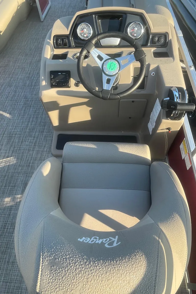 Slide: The Image of 2024 Ranger Reata 200C boat cockpit with steering wheel and dashboard controls. - 5