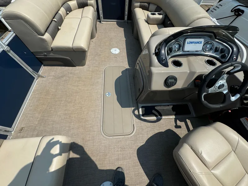 Slide: The Image of 2020 Sun Tracker Party Barge 22 Tri Toon RF XP3 interior with beige seating and control panel. - 15