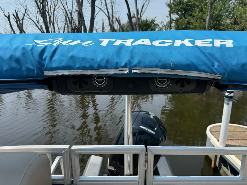 Slide: The Image of 2020 Sun Tracker Party Barge 22 Tri Toon RF XP3 with blue canopy on a calm lake. - 23