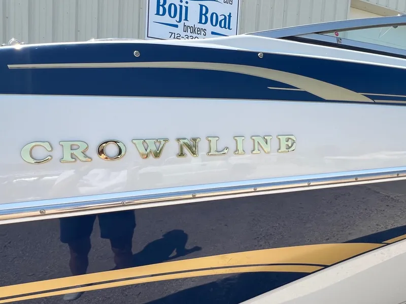 Slide: The Image of 2001 Crownline 192 BR boat with gold lettering and blue accents. - 1
