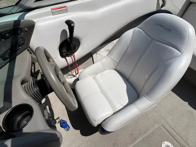 Slide: The Image of 2001 Crownline 192 BR boat interior with steering wheel and white captain's seat. - 12