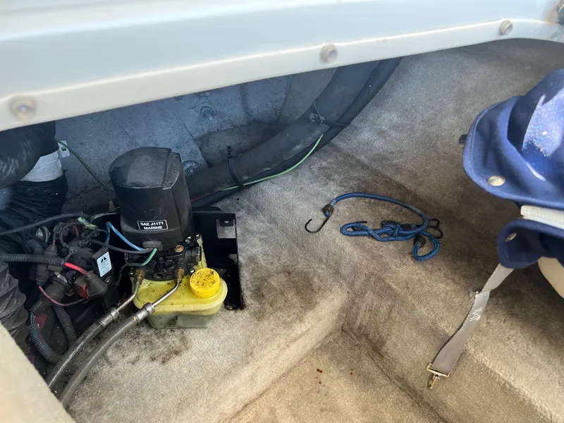 Slide: The Image of 2001 Crownline 192 BR boat interior showing engine compartment and marine equipment. - 16