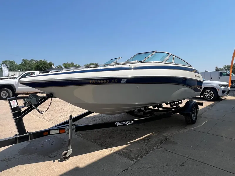 Slide: The Image of 2001 Crownline 192 BR boat on trailer, parked outdoors under clear sky. - 4