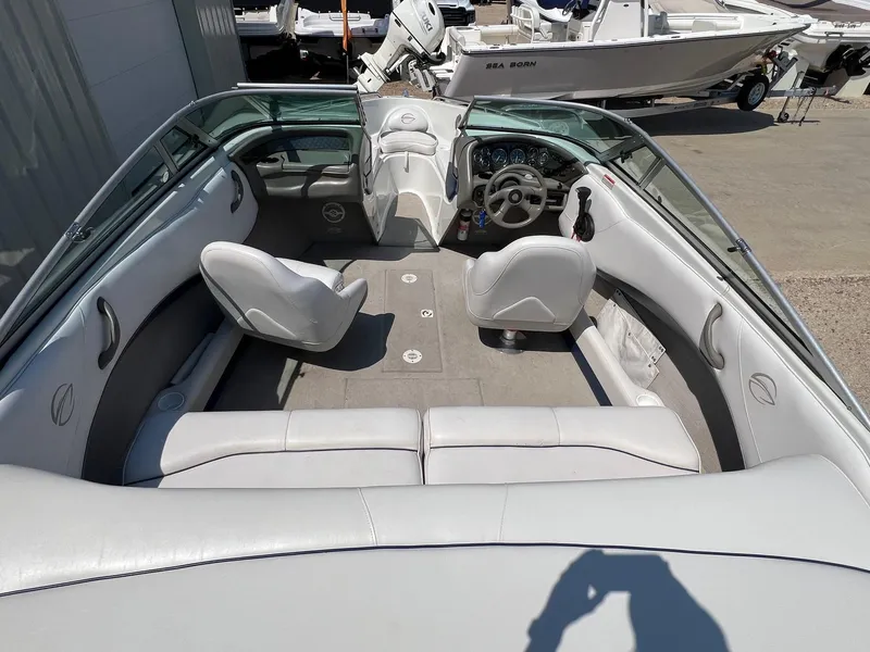 Slide: The Image of 2001 Crownline 192 BR boat interior with white seating and steering wheel. - 6