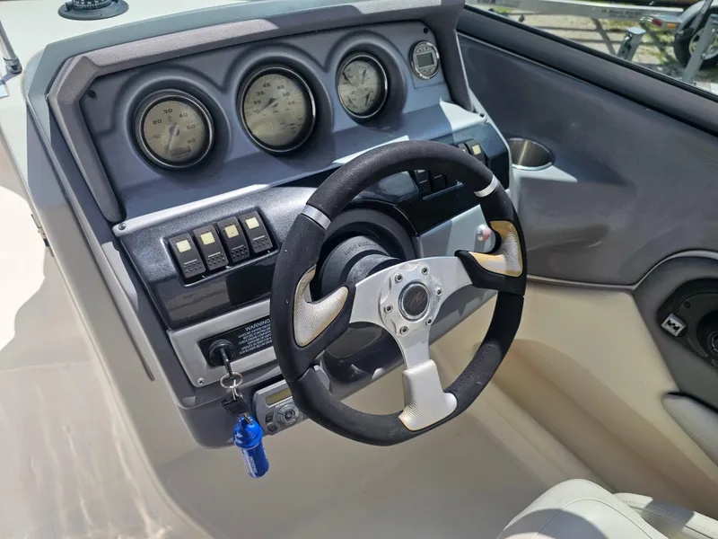 Slide: The Image of 2007 Monterey 220 EX boat dashboard with steering wheel and gauges. - 10