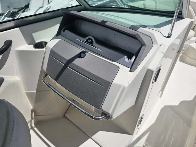 Slide: The Image of 2007 Monterey 220 EX boat dashboard with storage compartment. - 11