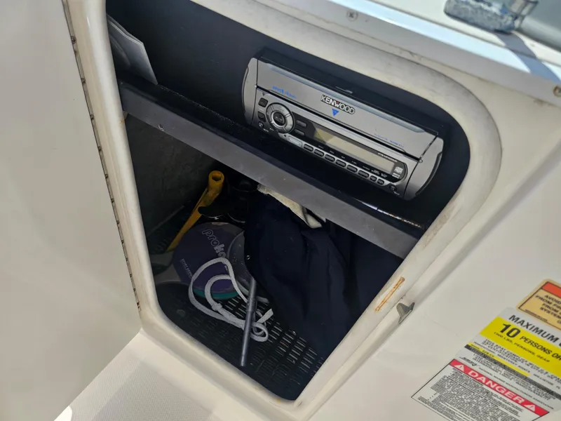 Slide: The Image of Storage compartment in a 2007 Monterey 220 EX boat with Kenwood stereo system. - 12