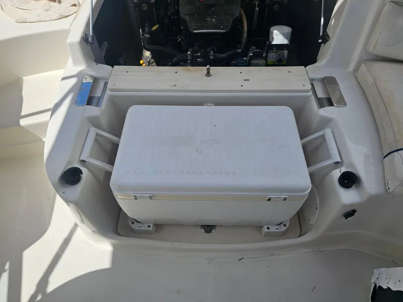 Slide: The Image of 2007 Monterey 220 EX boat interior with cooler and engine compartment. - 16