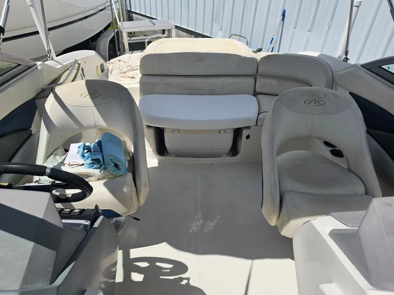 Slide: The Image of Interior of a 2007 Monterey 220 EX boat with beige seating and steering wheel. - 18