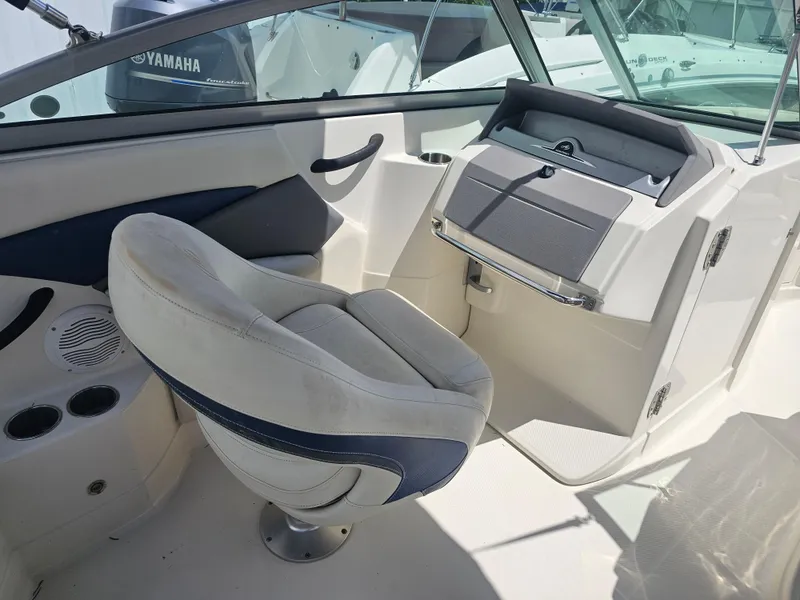 Slide: The Image of Interior of a 2007 Monterey 220 EX boat with helm and seating. - 19