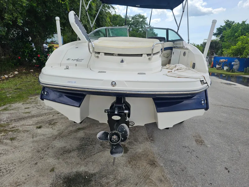 Slide: The Image of 2007 Monterey 220 EX boat, rear view, parked on a road with trees in background. - 3