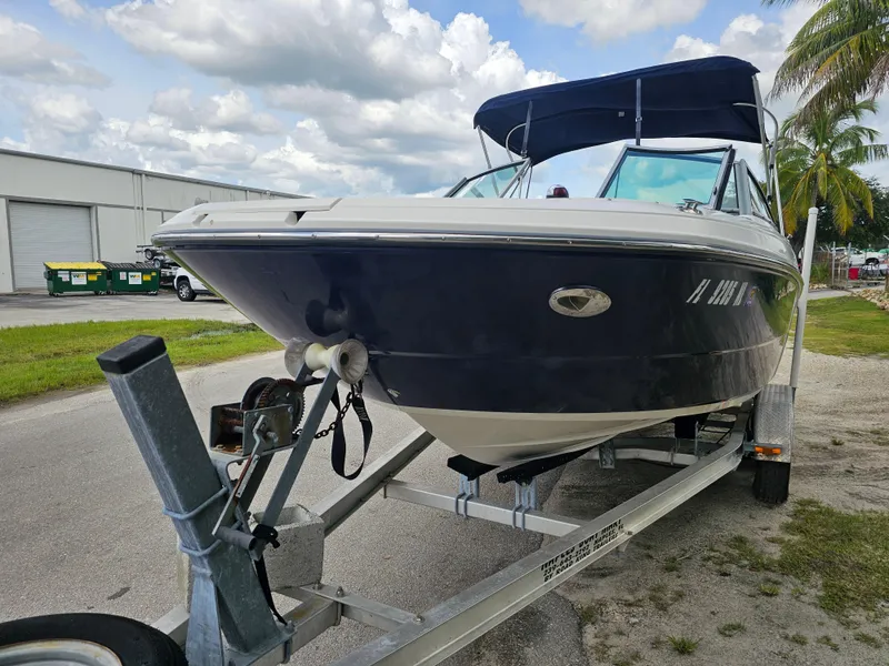 Slide: The Image of 2007 Monterey 220 EX boat on trailer, parked outdoors under cloudy sky. - 6