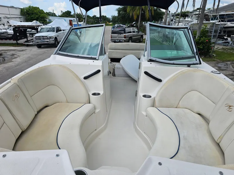 Slide: The Image of 2007 Monterey 220 EX boat interior with white seating and open deck layout. - 7