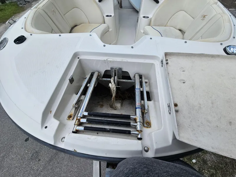 Slide: The Image of 2007 Monterey 220 EX boat with open storage compartment and seating area. - 8