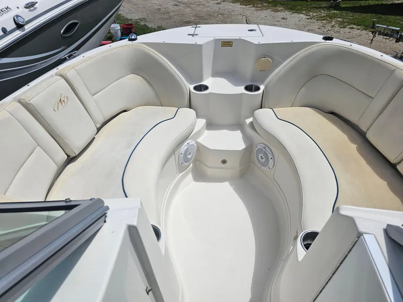 Slide: The Image of 2007 Monterey 220 EX boat interior with white seating and cup holders. - 9