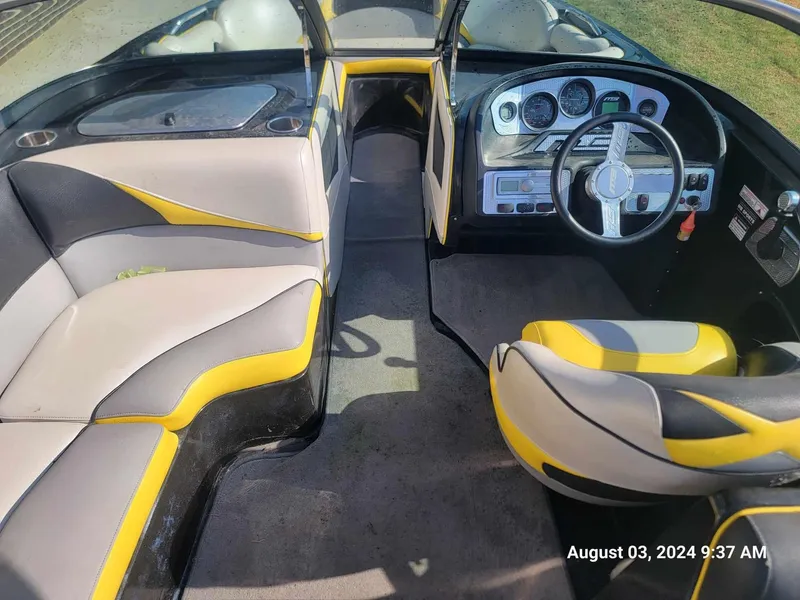Slide: The Image of Interior of 2013 MB F21 Tomcat boat with yellow and gray seating, dashboard view. - 13