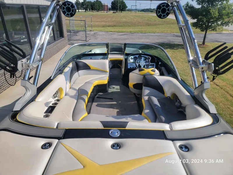 Slide: The Image of 2013 MB F21 Tomcat boat interior with yellow accents and modern dashboard. - 14