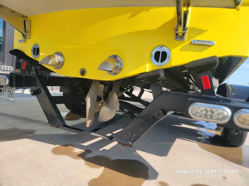 Slide: The Image of Yellow MB F21 Tomcat boat on trailer, showing propeller and exhaust, August 2024. - 4
