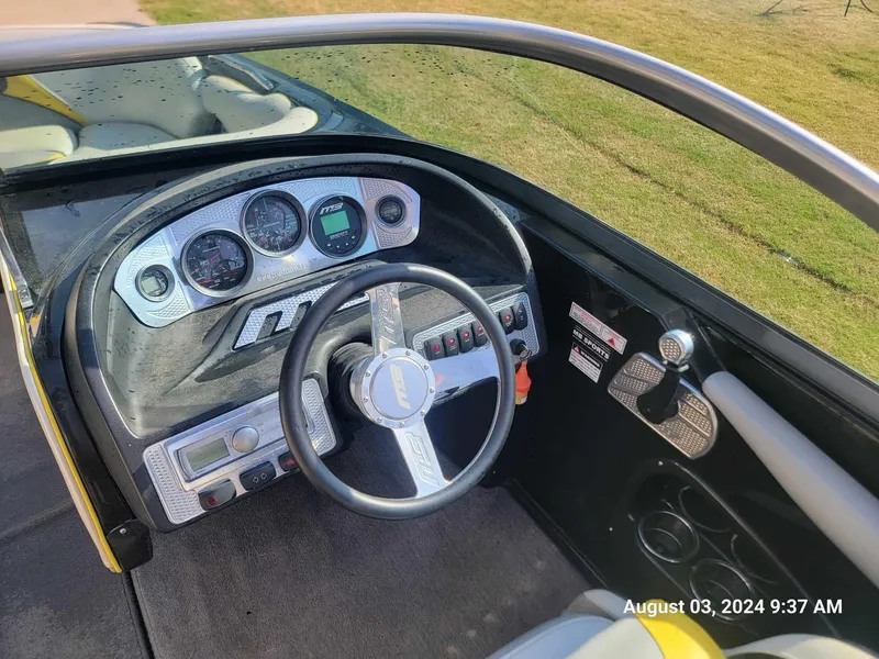 Slide: The Image of Cockpit of 2013 MB F21 Tomcat boat with steering wheel and dashboard controls. - 6
