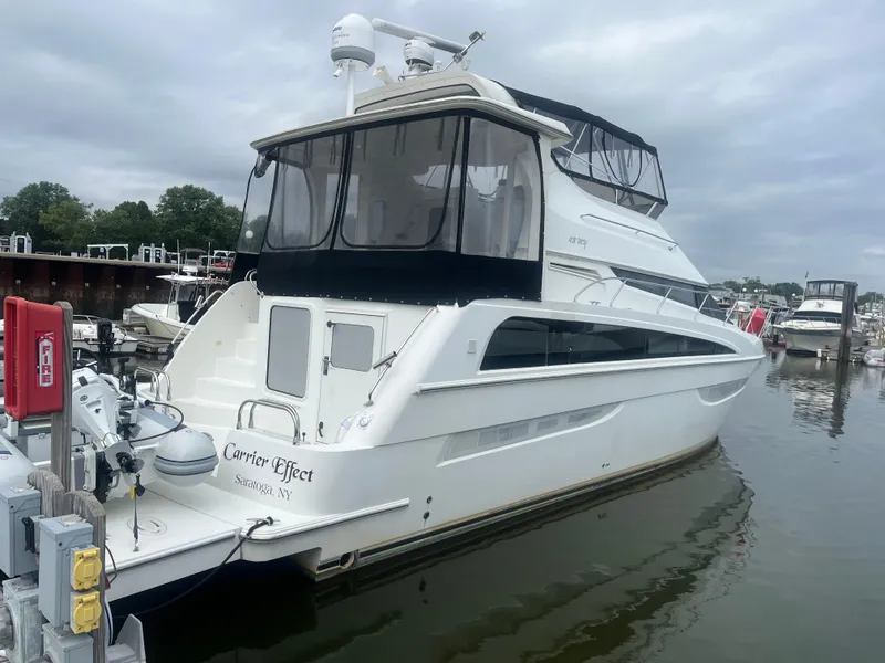 Slide: The Image of 2006 Carver 430 Cockpit Motor Yacht docked in a marina, overcast sky. - 1