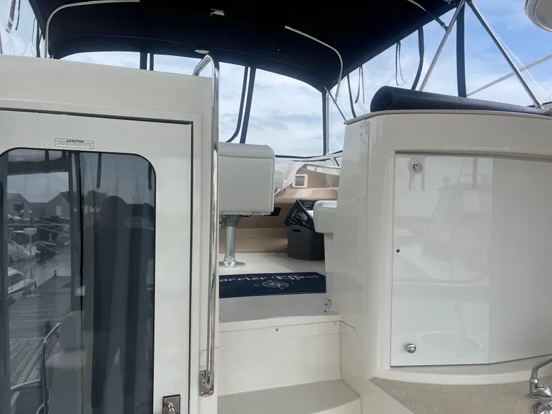 Slide: The Image of 2006 Carver 430 Cockpit Motor Yacht interior with seating and helm area. - 10