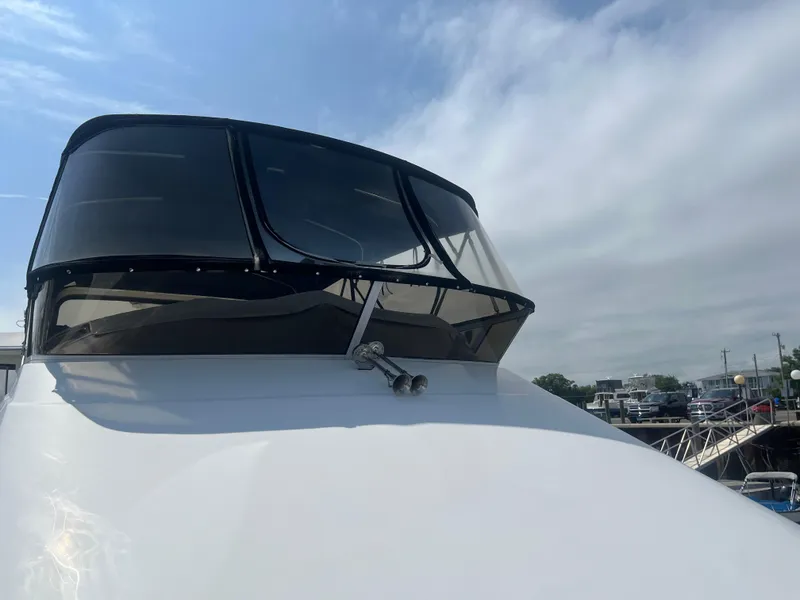 Slide: The Image of 2006 Carver 430 Cockpit Motor Yacht with sleek design and tinted windows. - 11