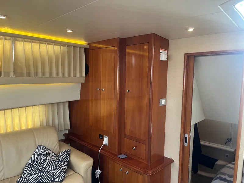 Slide: The Image of Interior of 2006 Carver 430 Cockpit Motor Yacht with wood cabinets and leather seating. - 16