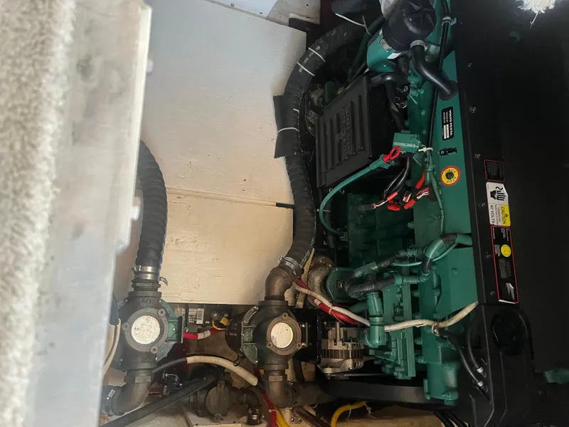 Slide: The Image of Engine compartment of 2006 Carver 430 Cockpit Motor Yacht, featuring mechanical components. - 20
