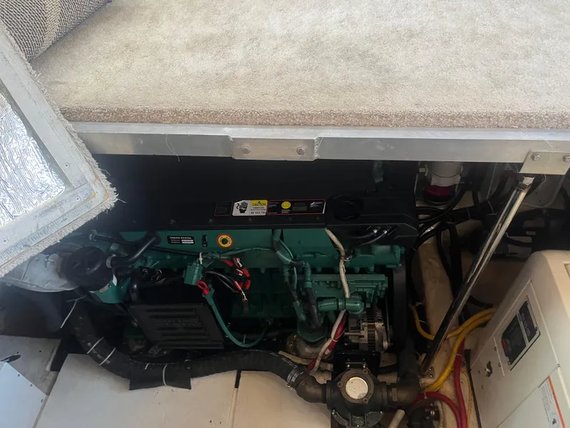 Slide: The Image of Engine compartment of 2006 Carver 430 Cockpit Motor Yacht, showing mechanical components. - 21