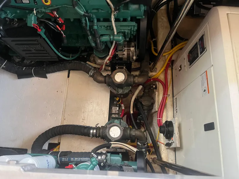 Slide: The Image of Engine room of 2006 Carver 430 Cockpit Motor Yacht with visible wiring and components. - 22