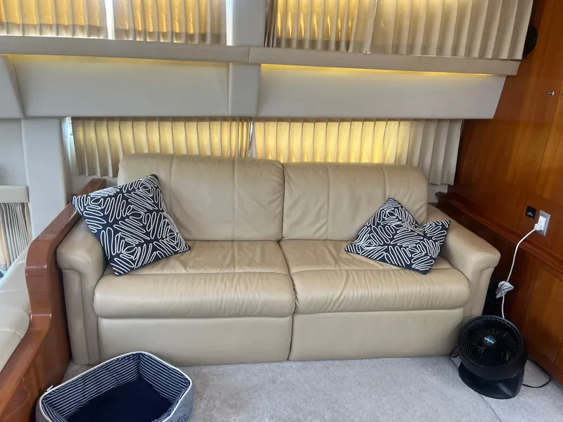 Slide: The Image of Beige leather sofa with patterned pillows in 2006 Carver 430 Cockpit Motor Yacht interior. - 23