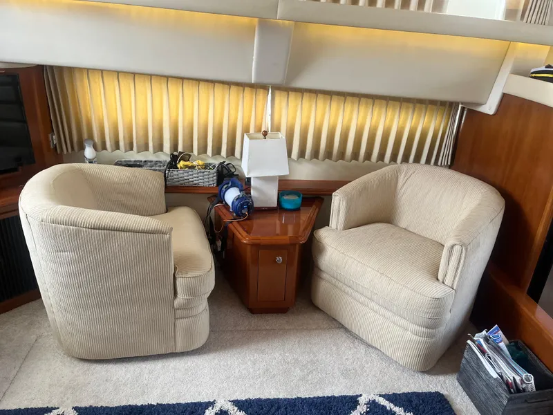 Slide: The Image of Interior of 2006 Carver 430 Cockpit Motor Yacht with cozy seating and table. - 24