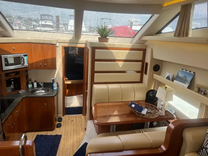 Slide: The Image of Interior of 2006 Carver 430 Cockpit Motor Yacht with kitchen and dining area. - 25