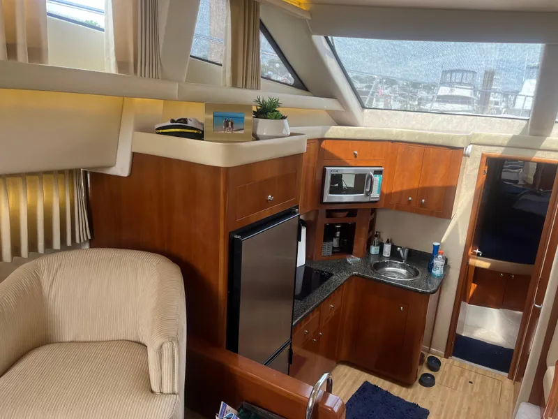Slide: The Image of Interior of 2006 Carver 430 Cockpit Motor Yacht with kitchenette and seating area. - 26