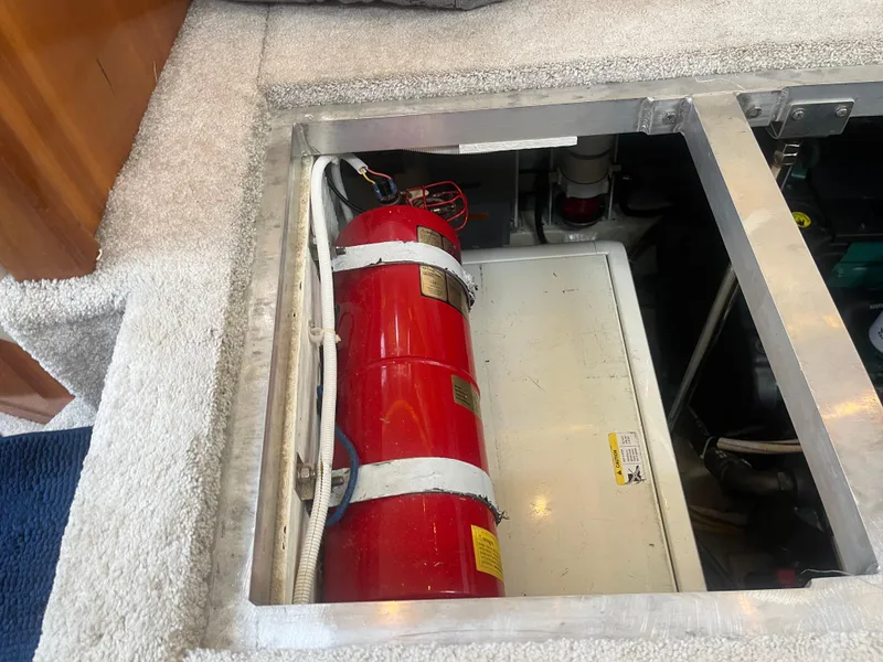 Slide: The Image of 2006 Carver 430 Cockpit Motor Yacht engine compartment with fire extinguisher. - 27