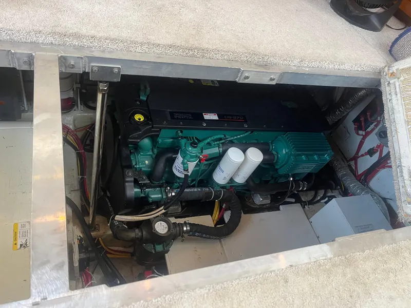 Slide: The Image of Engine compartment of 2006 Carver 430 Cockpit Motor Yacht, showcasing mechanical components. - 28