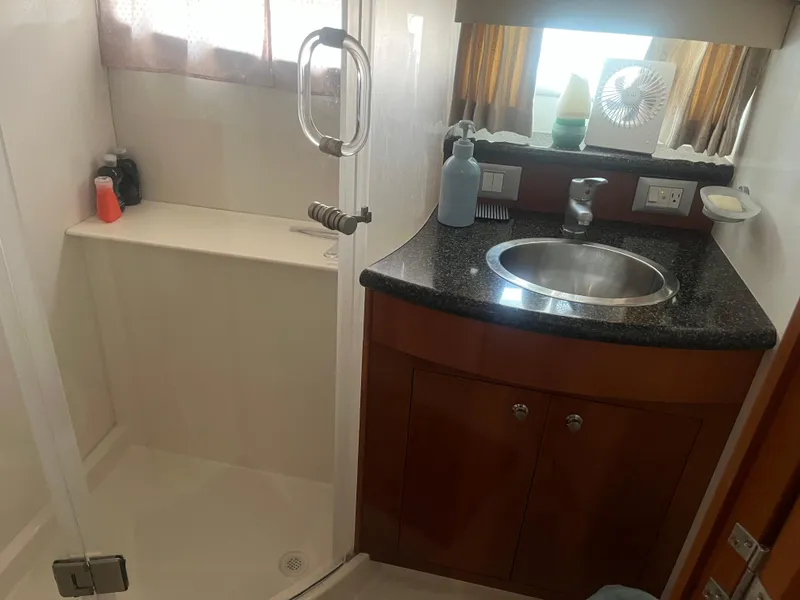 Slide: The Image of Bathroom interior of 2006 Carver 430 Cockpit Motor Yacht with sink and shower. - 30