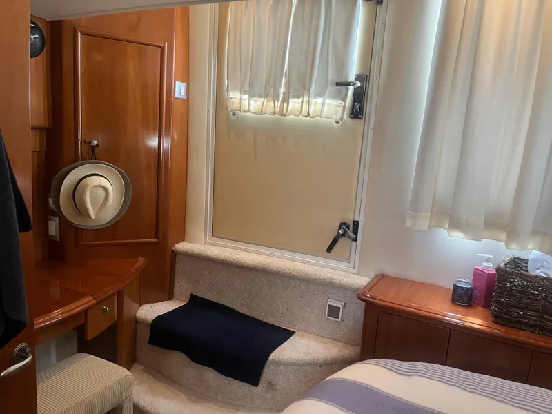 Slide: The Image of Interior of 2006 Carver 430 Cockpit Motor Yacht with wooden cabinetry and cozy decor. - 31