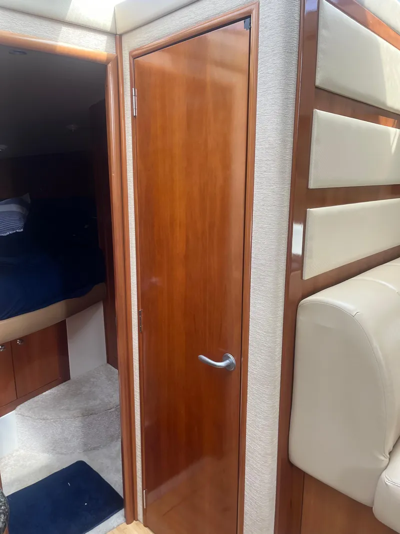 Slide: The Image of Interior of 2006 Carver 430 Cockpit Motor Yacht with wooden door and seating area. - 33