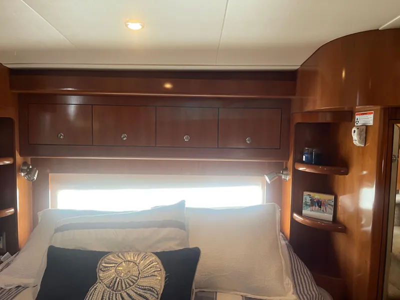 Slide: The Image of Interior of 2006 Carver 430 Cockpit Motor Yacht with wooden cabinets and cozy bedding. - 34