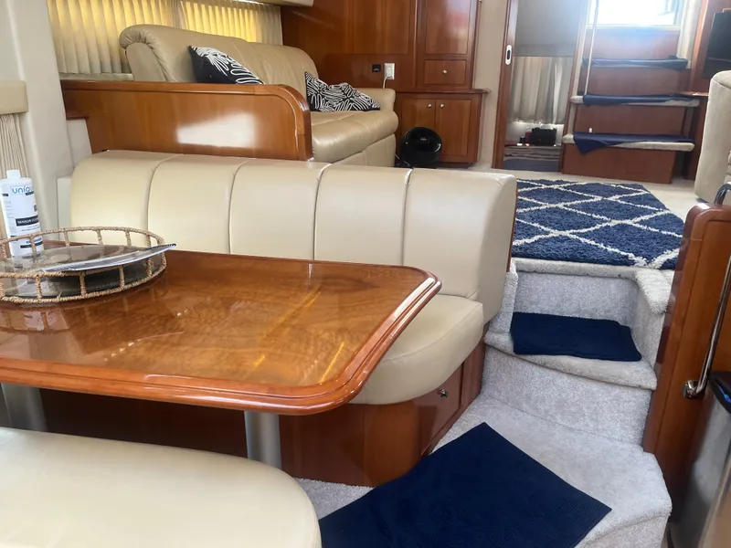 Slide: The Image of Interior of 2006 Carver 430 Cockpit Motor Yacht with elegant seating and wooden table. - 37