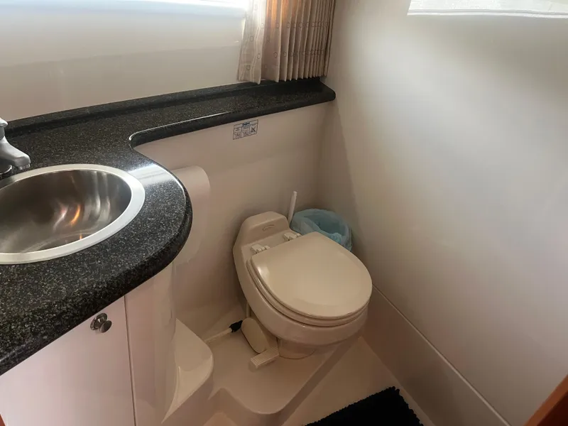 Slide: The Image of 2006 Carver 430 Cockpit Motor Yacht bathroom with sink and toilet. - 38