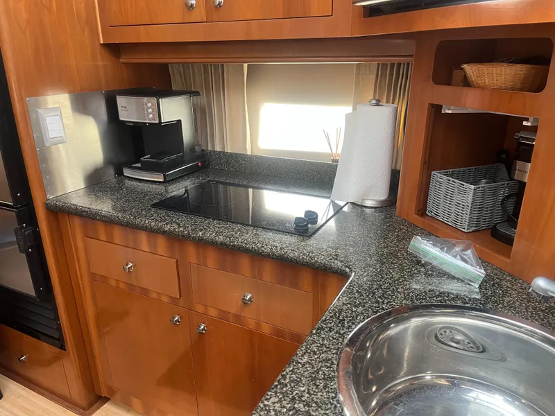 Slide: The Image of 2006 Carver 430 Cockpit Motor Yacht kitchen with granite countertops and modern appliances. - 42