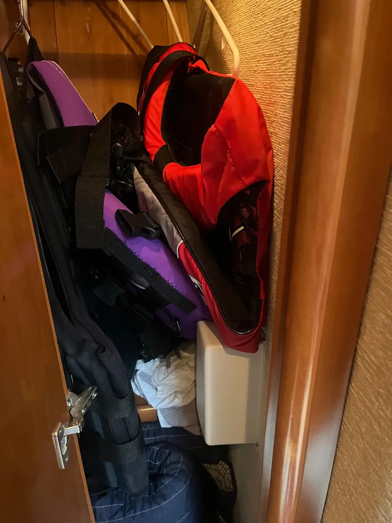 Slide: The Image of Life jackets stored in a closet on a 2006 Carver 430 Cockpit Motor Yacht. - 44